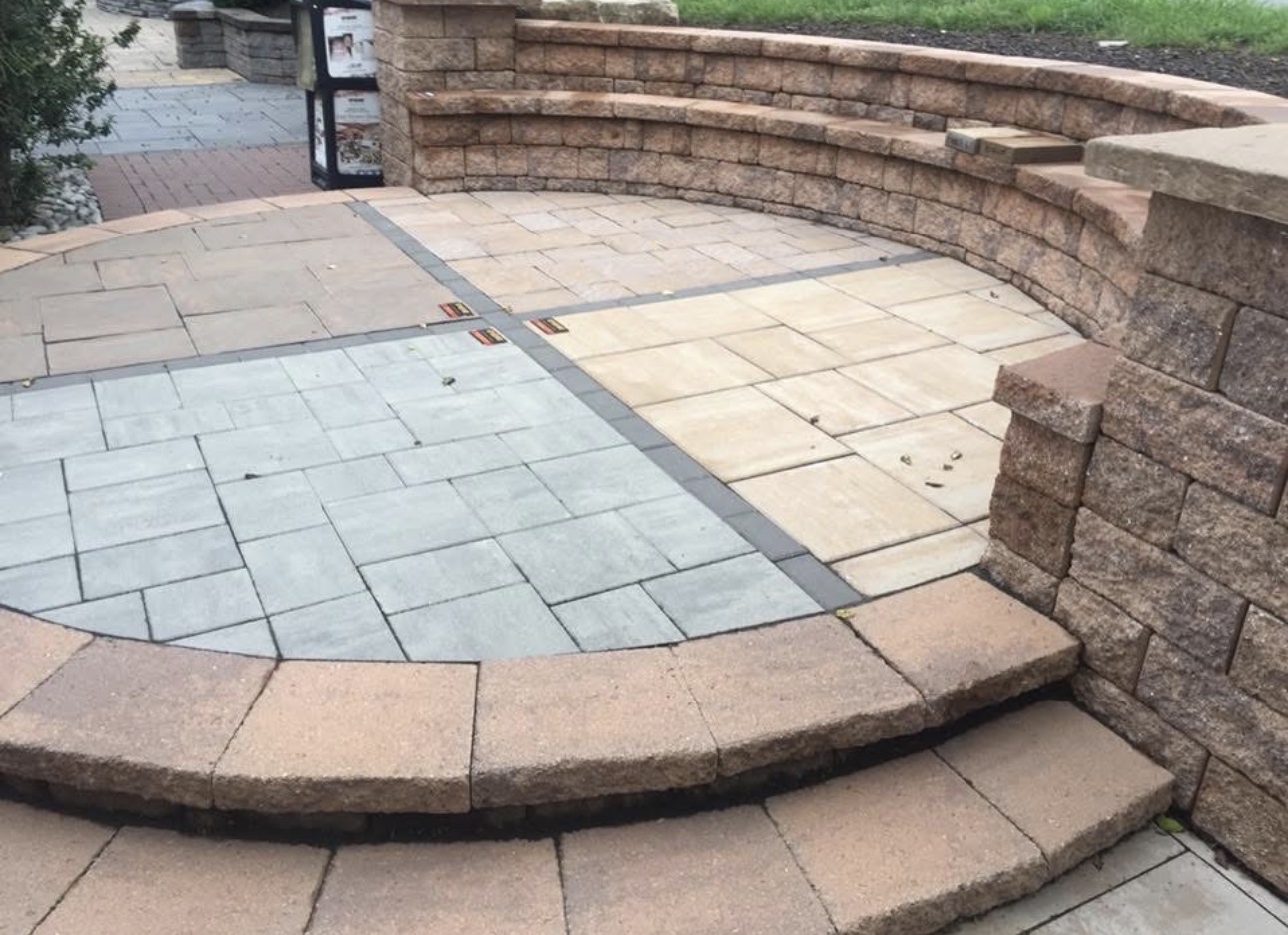 Brick pergola columns over a stone paver patio